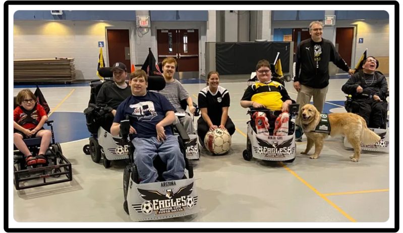 Motor City Eagles team with their game-day dog mascot